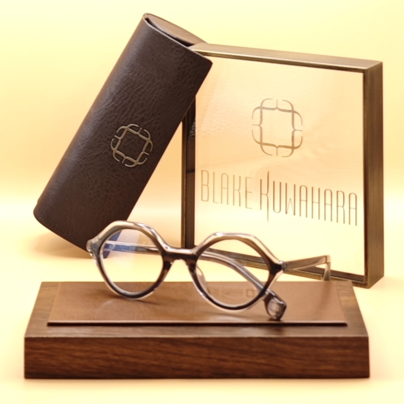 Blake Kuwahara's Curlett small oval optical frames with an unusual, slightly diamond-shaped lens profile in translucent brown-grey tortoiseshell.