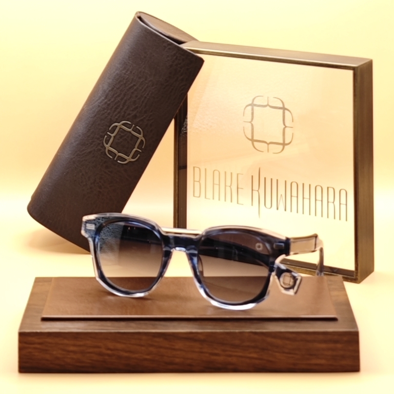 Blake Kuwahara's Haycock square sunglasses in blue-grey and clear layered acetate with dark gradient lenses.