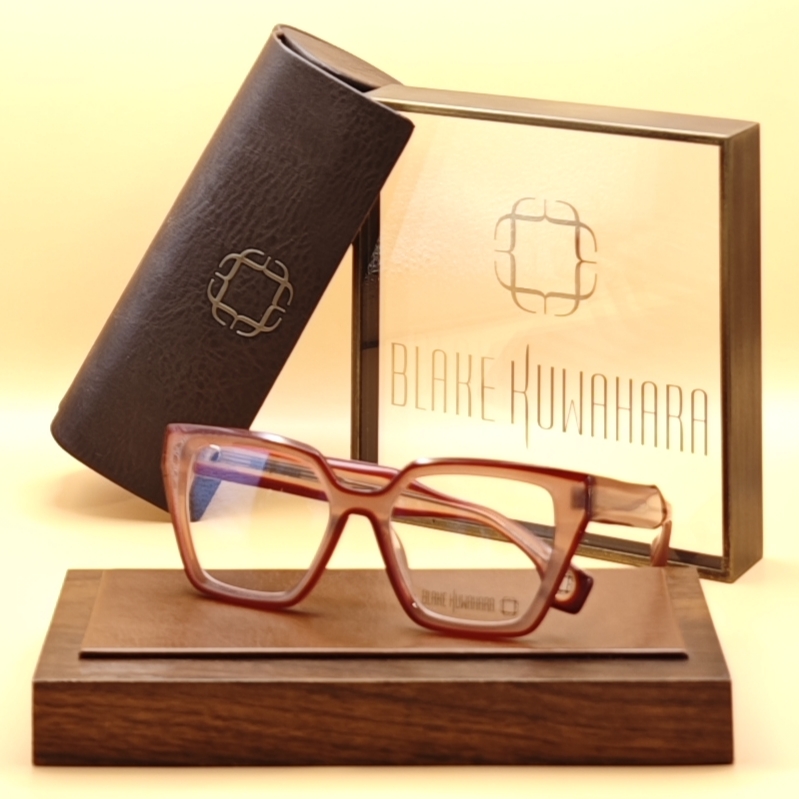 Blake Kuwahara's Janeway oversized, angular optical frame in a translucent rosy pink and red acetate.