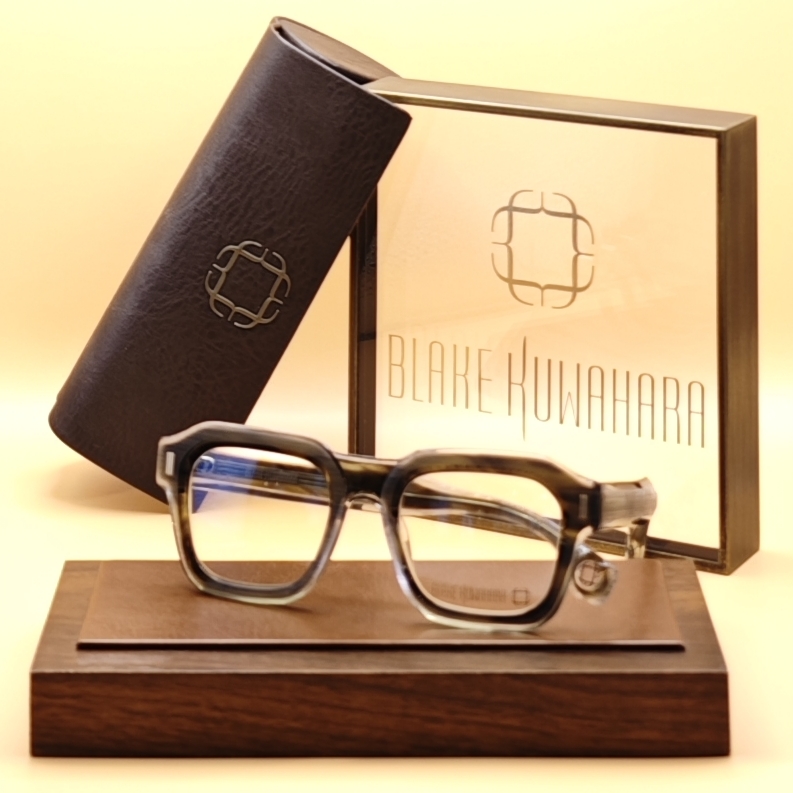 Blake Kuwahara's BK 1036 bold square optical frame in a smoky grey and brown tortoiseshell acetate layered over clear acetate.