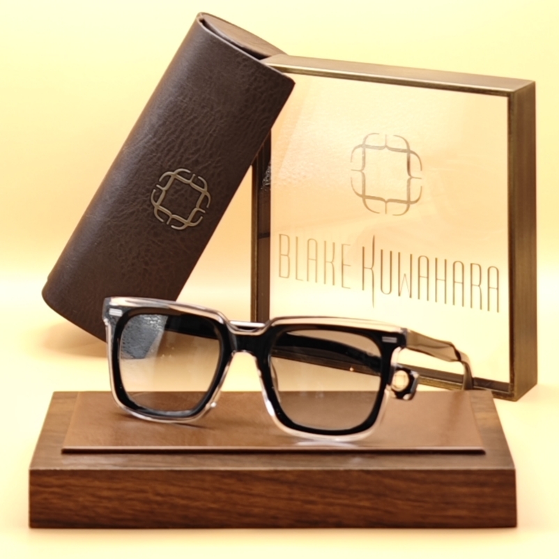 Blake Kuwahara's Buff square sunglasses in a layered clear acetate with a black acetate browline and lens trim.