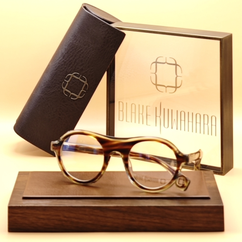 Blake Kuwahara's Prouve small, rounded-oval optical frames in warm amber and brown classic tortoiseshell acetate.
