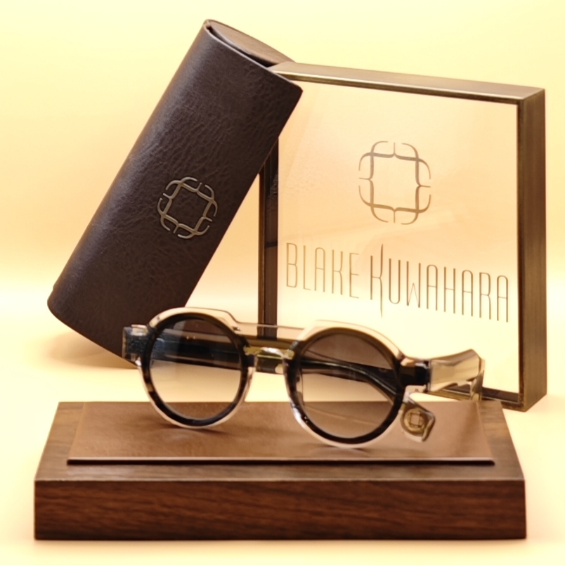 Blake Kuwahara's Llogg circular sunglasses with a double bridge, featuring black/white marbled acetate and dark tinted lenses.