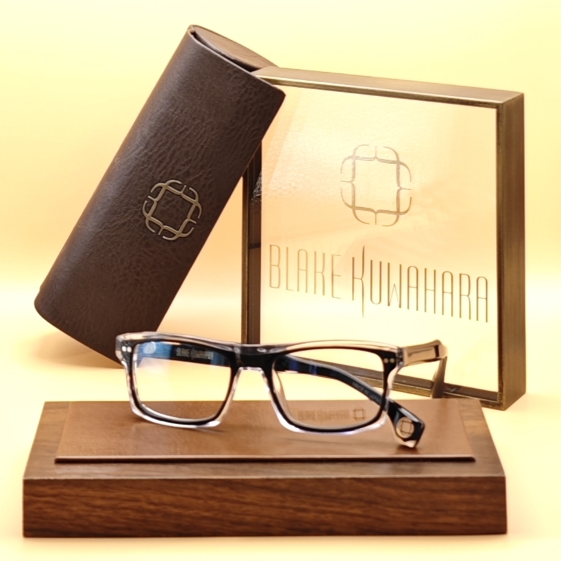 Blake Kuwahara Albers rectangular optical frame with a gradient acetate design, blending black, clear, and blue tones, showcased with the brand's case and box.