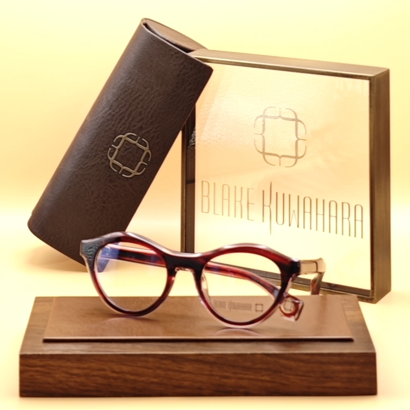 Blake Kuwahara Caron cat-eye optical frames in a rich burgundy and black tortoiseshell acetate with a subtle textured detail on the upper rim.