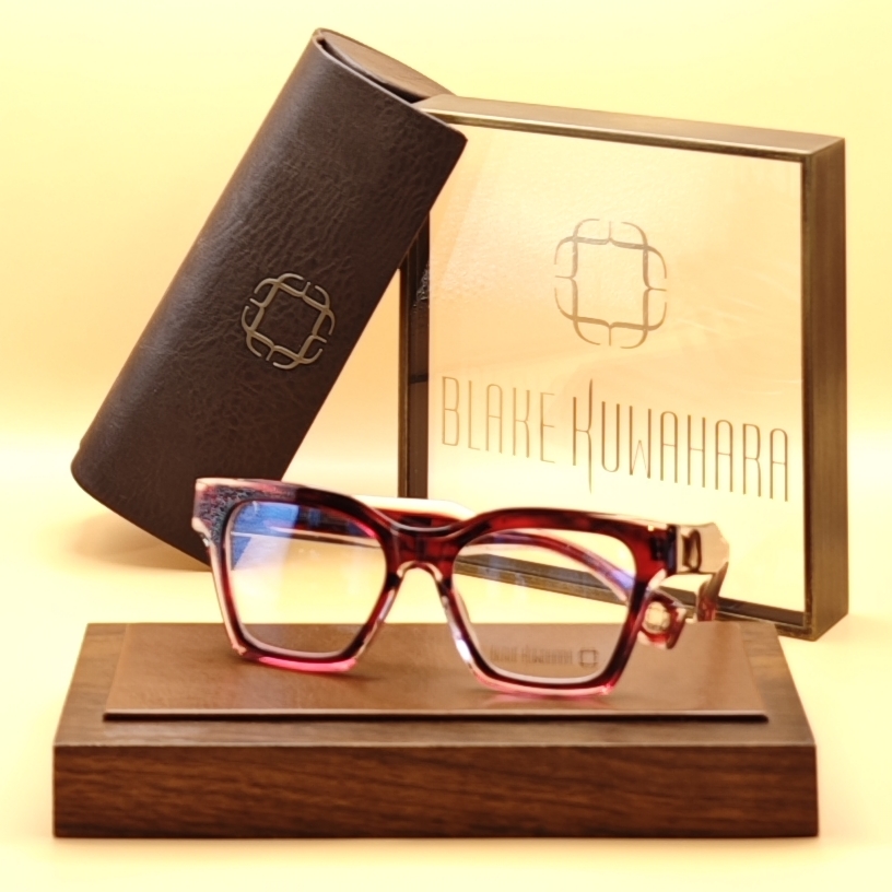 Blake Kuwahara's Skinner strong cat-eye glasses in layered red and pink acetate with a textured/glitter endpiece.