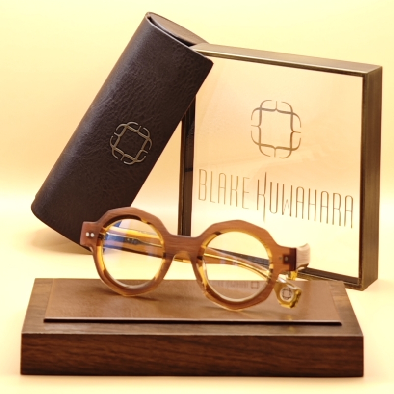 Blake Kuwahara's BK 1029 small, chunky round glasses in warm translucent amber acetate with bevelled edges.