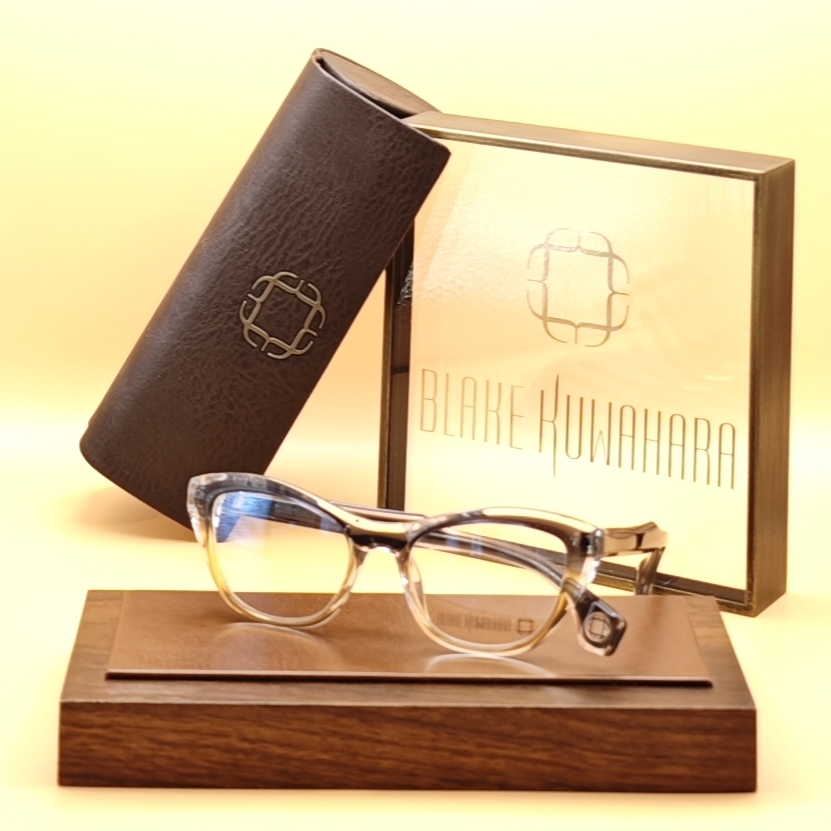 Blake Kuwahara's Bayer soft cat-eye glasses in a blend of clear, grey, and light tortoise acetate.