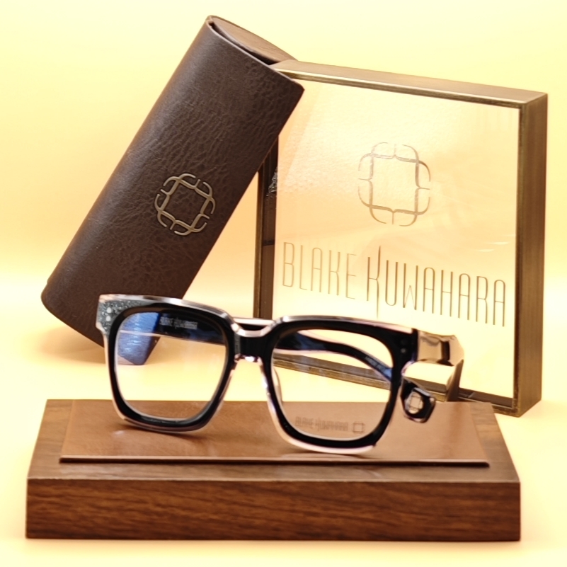 Blake Kuwahara's Spence square/rectangular glasses in black acetate with a speckled/textured detail on the endpieces.