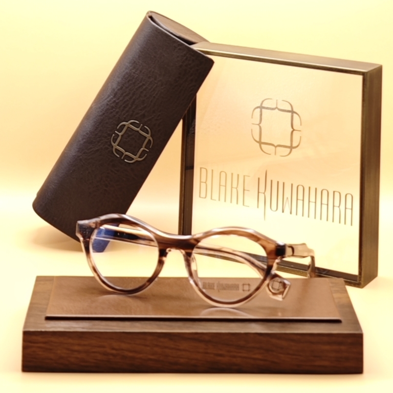 Blake Kuwahara's Caron rounded, keyhole bridge glasses in a warm brown and beige layered tortoise acetate.