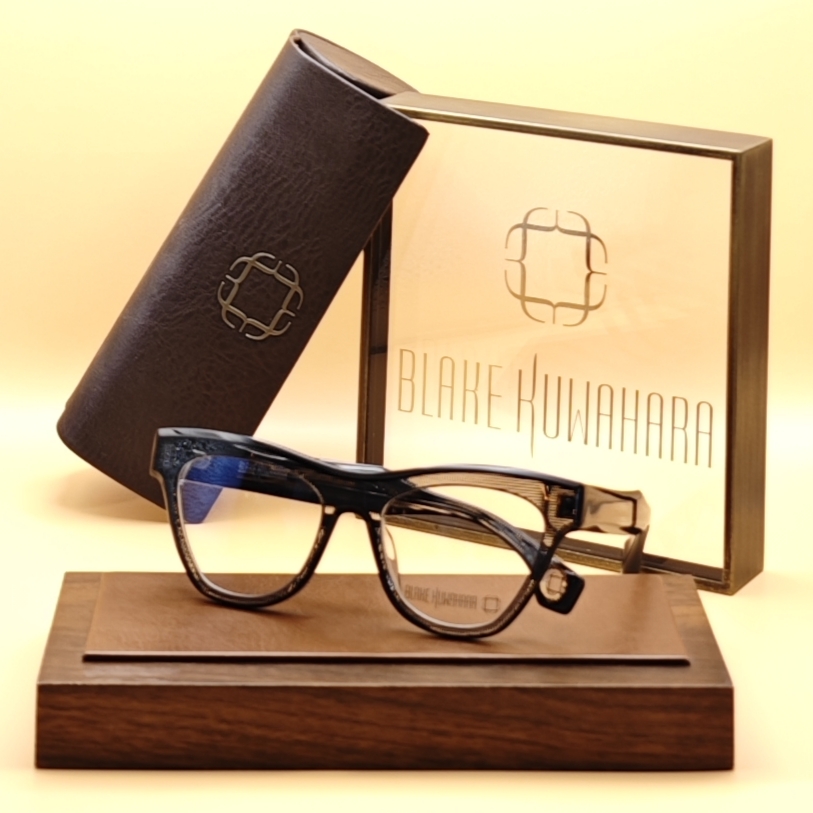 Blake Kuwahara's Ficket cat-eye glasses with a sweeping browline in black and clear marbled acetate.