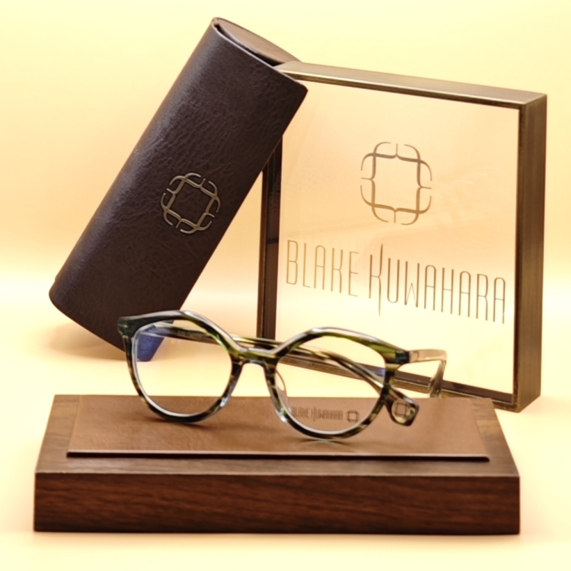 Blake Kuwahara's Conklin round-oval glasses in a vibrant green and black mottled tortoise acetate pattern.