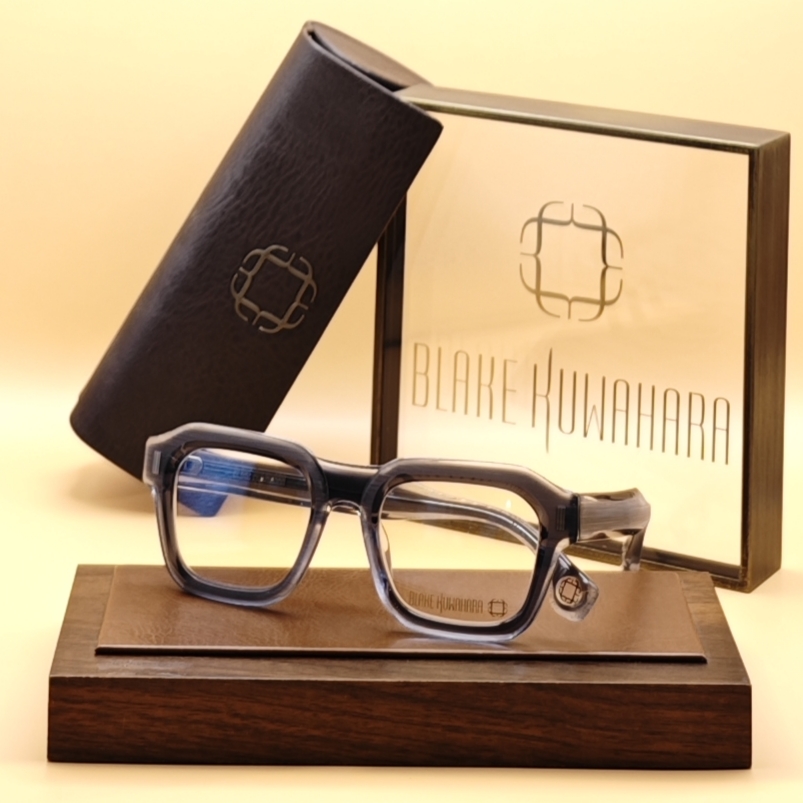 Blake Kuwahara BK 1036 glasses with a thick, two-tone gradient frame transitioning from dark grey to light grey/clear acetate.